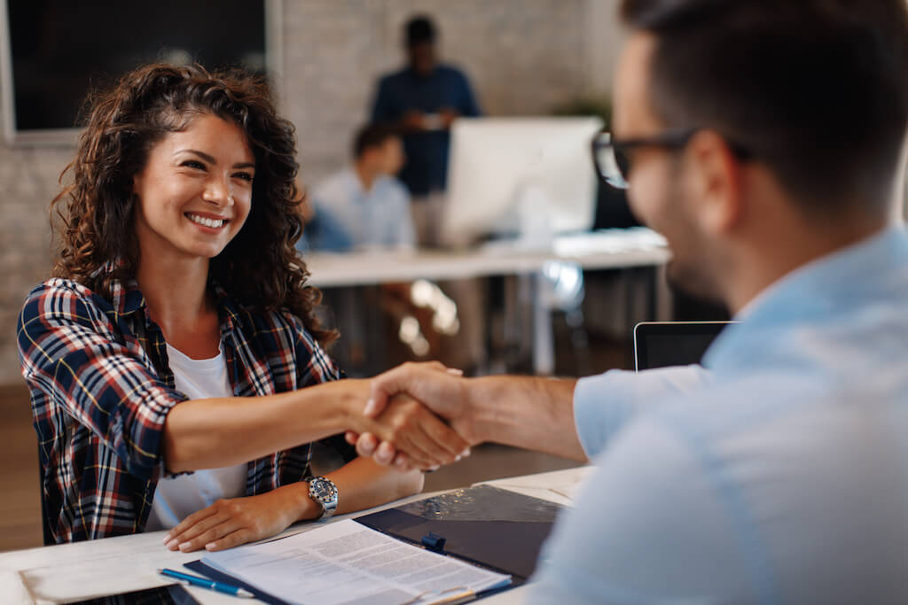 Woman shaking hands with her interviewer